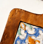 Close-up of the Azure Bloom floral tile pattern and glowing acacia wood texture
