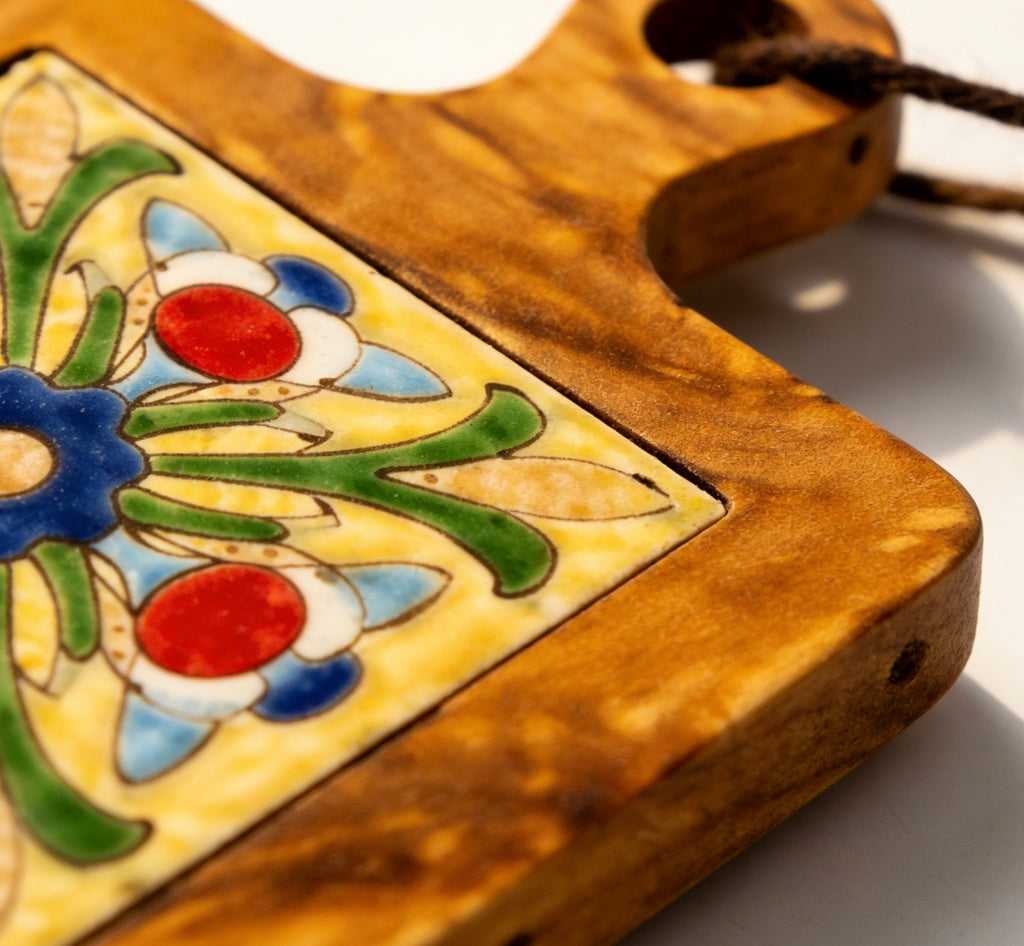 Close-up of the artisanal ceramic tile pattern and natural glowing acacia wood grain