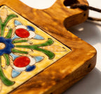 Close-up of the artisanal ceramic tile pattern and natural glowing acacia wood grain