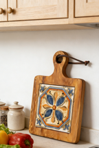 Handcrafted acacia serving board used as a decorative coaster for an elegant afternoon tea setting