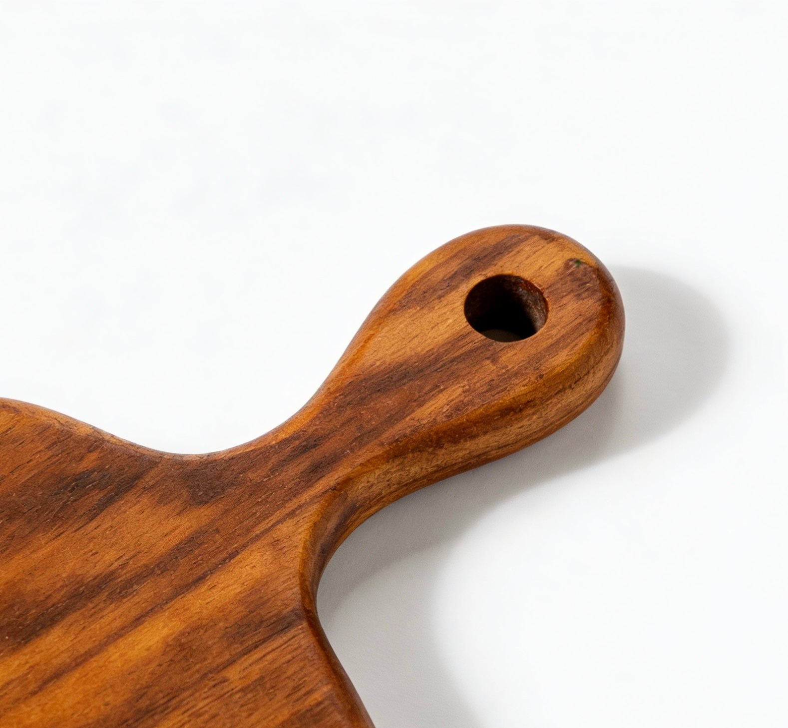 Solid teak board with built-in hanging loop for easy kitchen display and wall storage