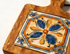 Close-up of the Mediterranean Bloom artisanal ceramic tile pattern with glowing acacia wood frame