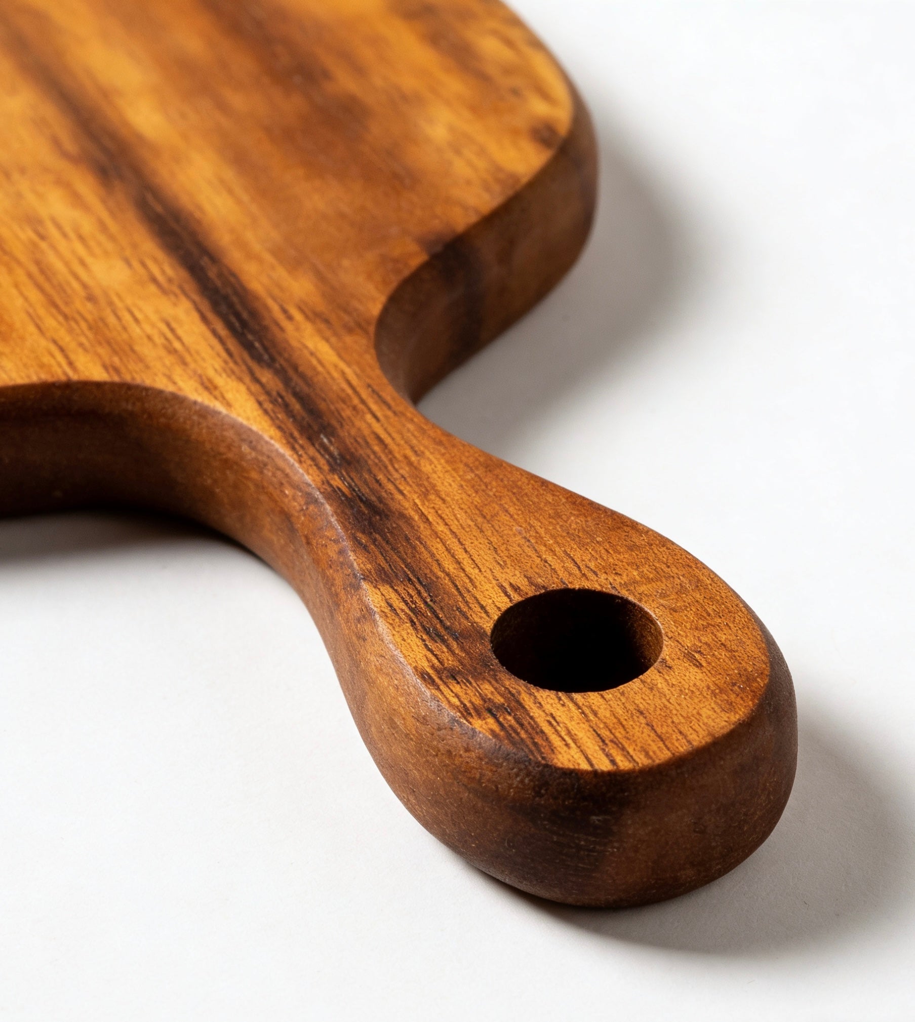 Sustainable acacia wood board with built-in hanging loop for easy kitchen storage and display